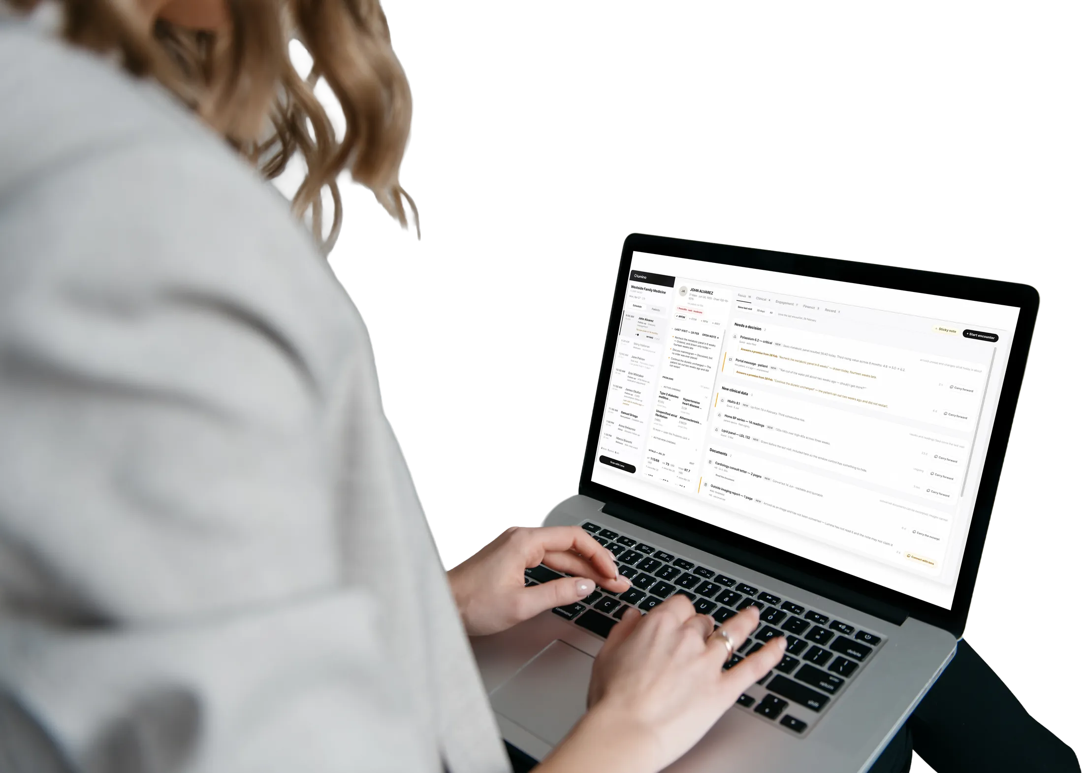 A clinician working in the Lumina patient chart on a laptop